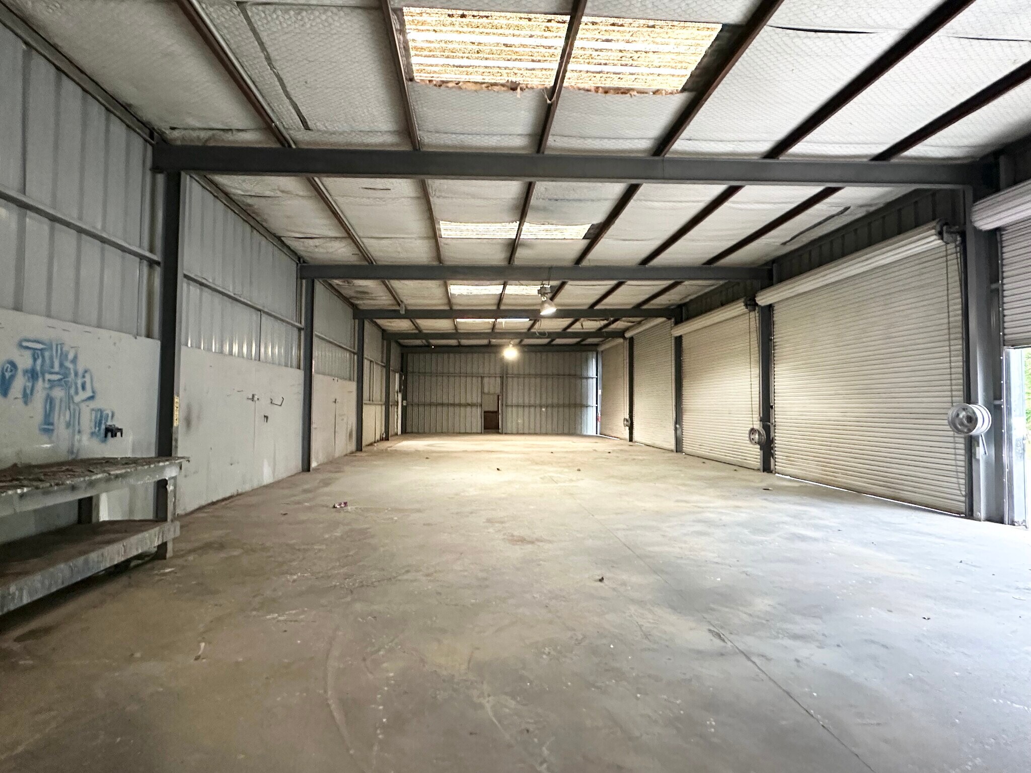 Long warehouse bay with multiple grade-level doors at 13626 Ann Louise Rd