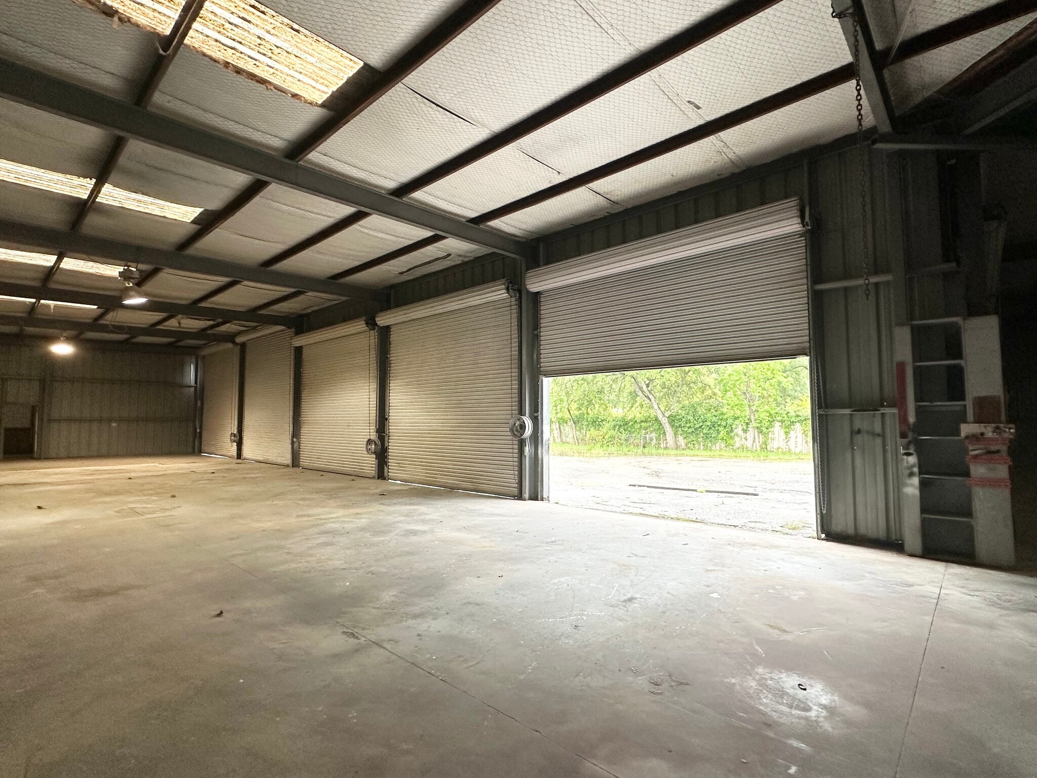 Warehouse loading area with several roll-up doors at 13626 Ann Louise Rd