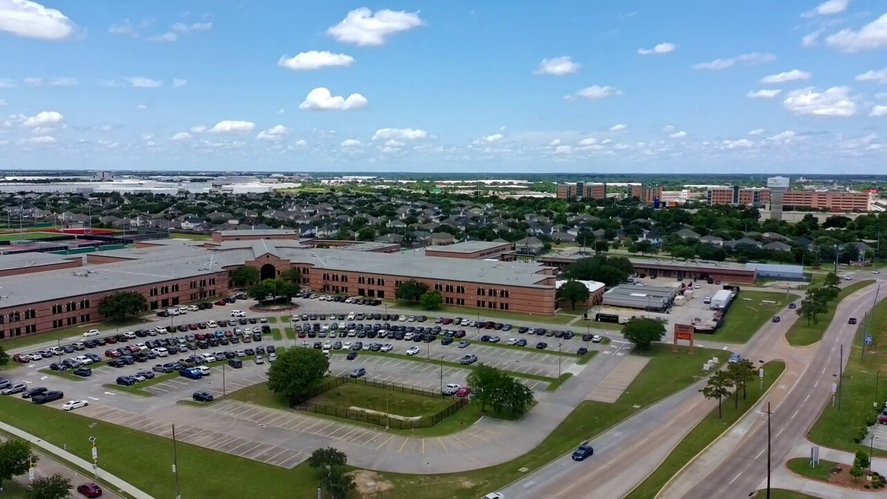 Wide aerial view of Eagles Landing and surrounding commercial area