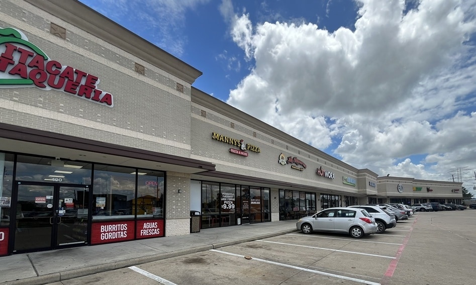 Close view of tenant storefront signage along the retail center