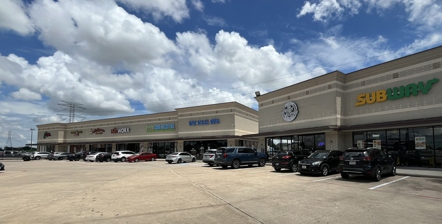 Parking court surrounded by retail tenant storefronts