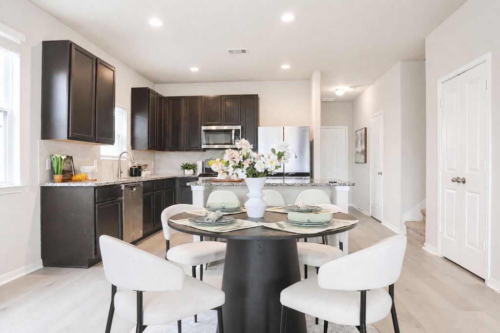 Kitchen and dining area with dark cabinetry