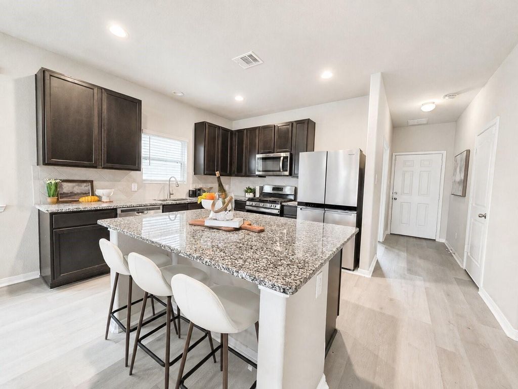 Kitchen island with seating and granite countertop