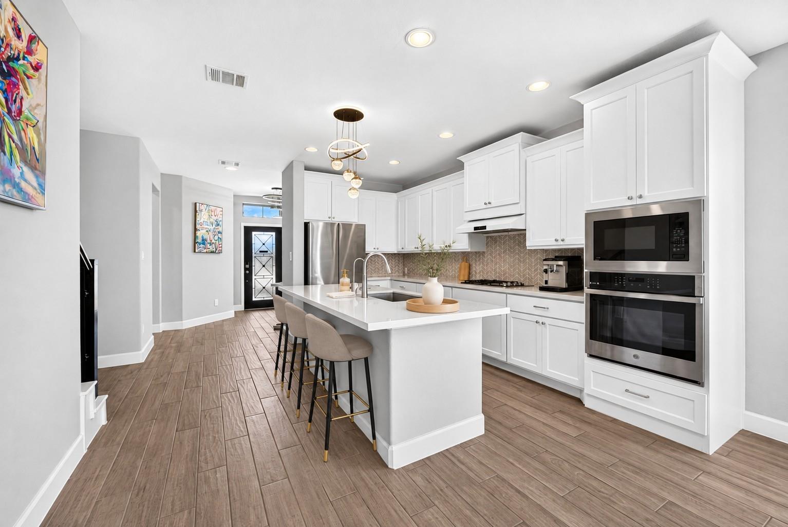 White kitchen with island at 2534 Alder Wood Ln