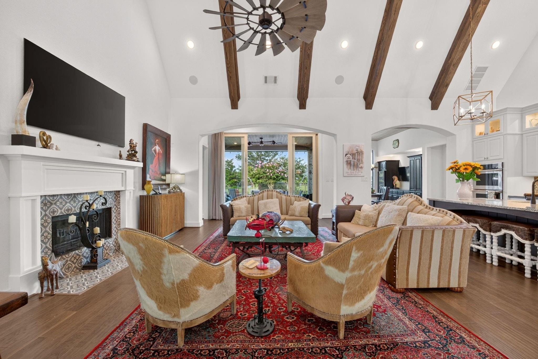 Living room with soaring ceilings and exposed beams at 2710 Merlin Way