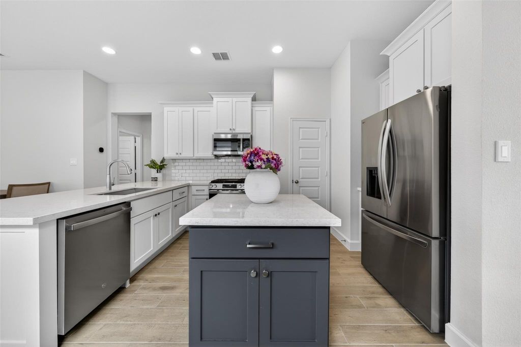 Kitchen island and stainless steel appliances at 2867 Orange Leaf Dr