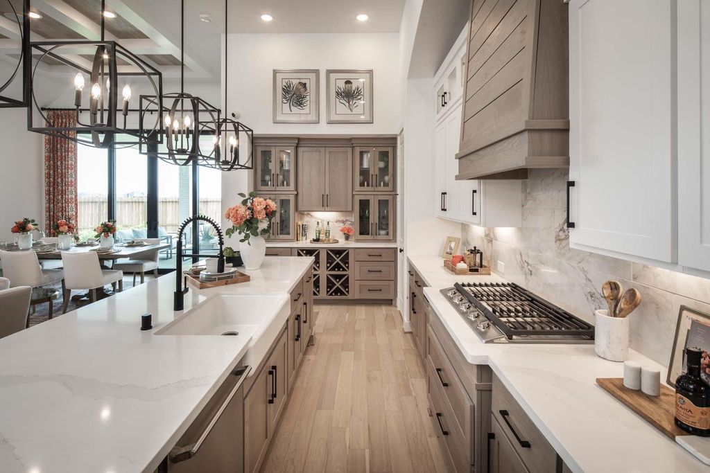 Kitchen island, gas cooktop and custom cabinetry at 29623 Apple Glen Court