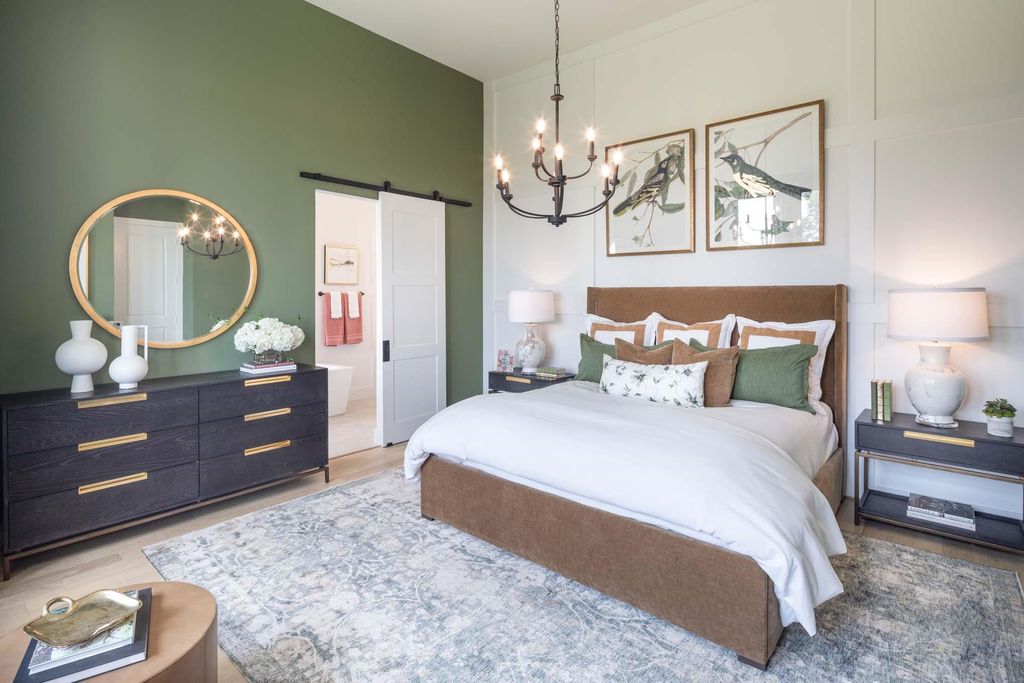 Primary bedroom with accent wall and barn door at 29623 Apple Glen Court