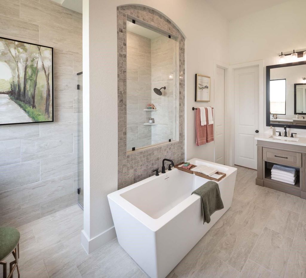 Primary bathroom soaking tub and tiled shower at 29623 Apple Glen Court
