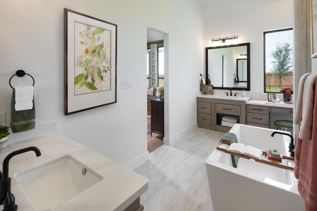 Primary bathroom double vanity and soaking tub at 29623 Apple Glen Court