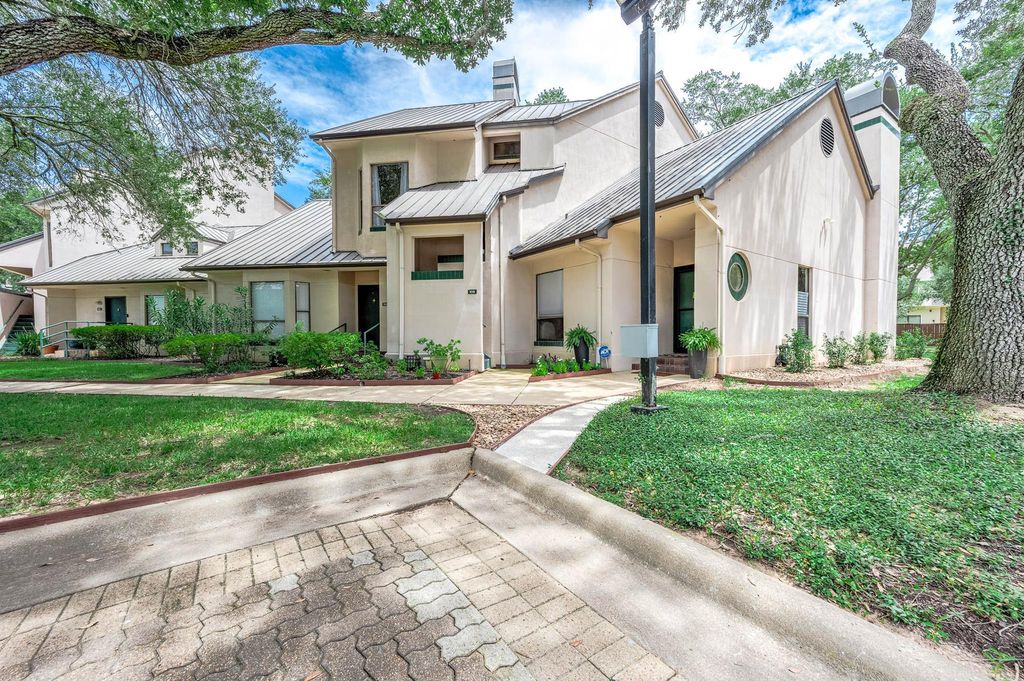 Tree-lined exterior walkway at 4144 Greystone Way Unit 105