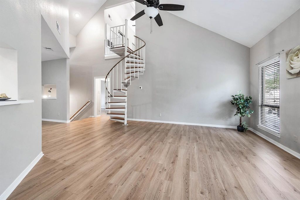 Open living space and spiral staircase at 4144 Greystone Way Unit 105
