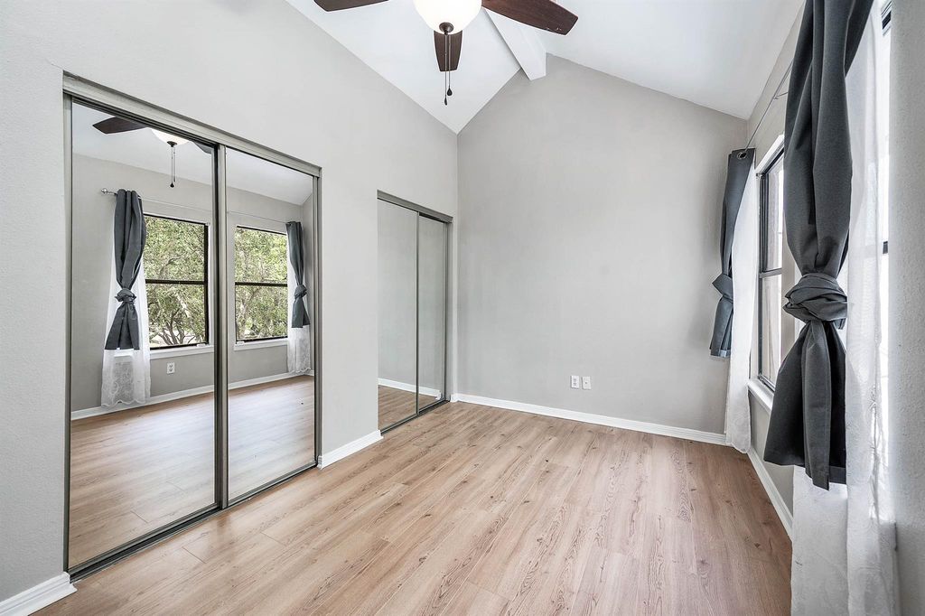 Bedroom with mirrored closet doors at 4144 Greystone Way Unit 105
