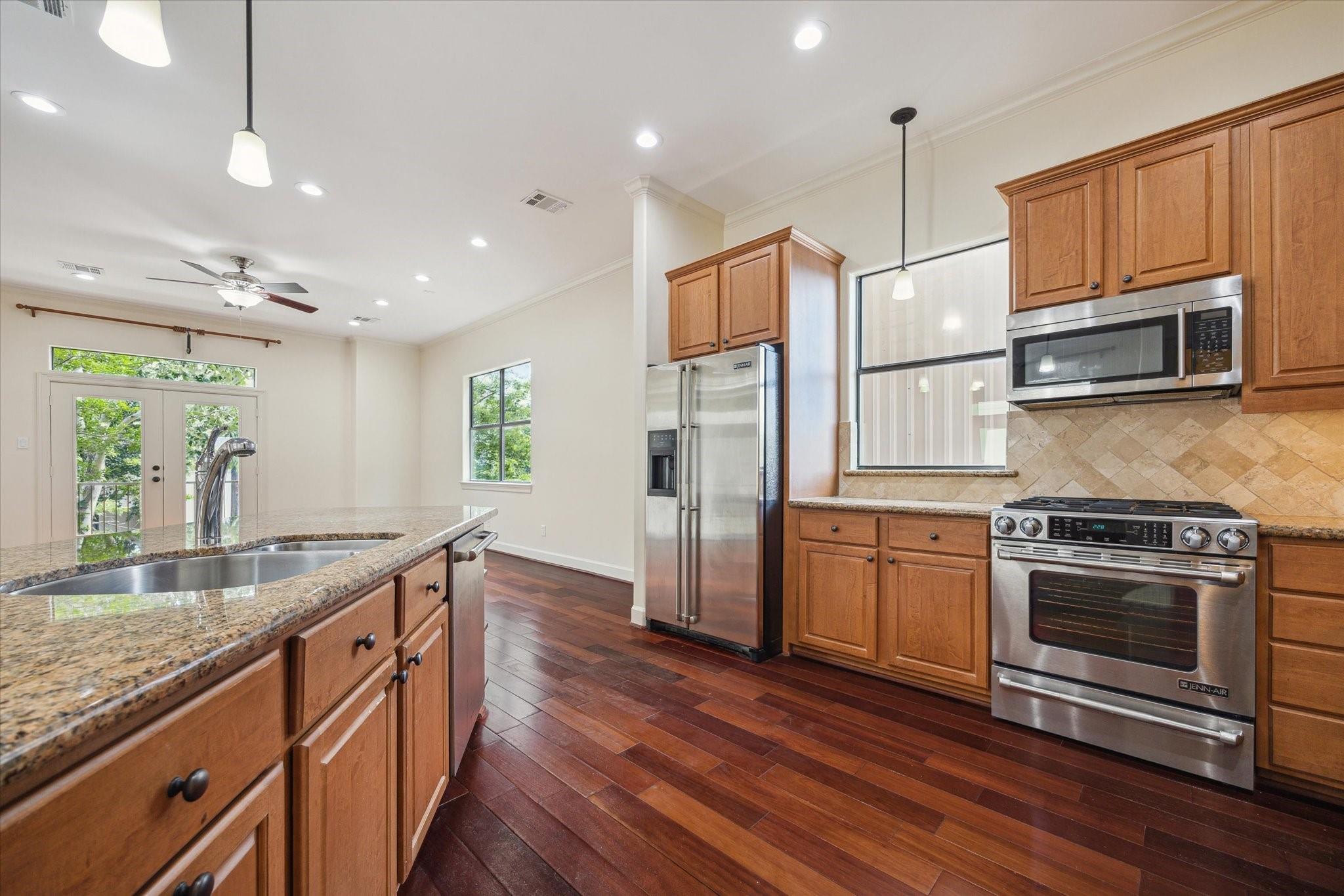 Kitchen island, gas range and stainless steel appliances