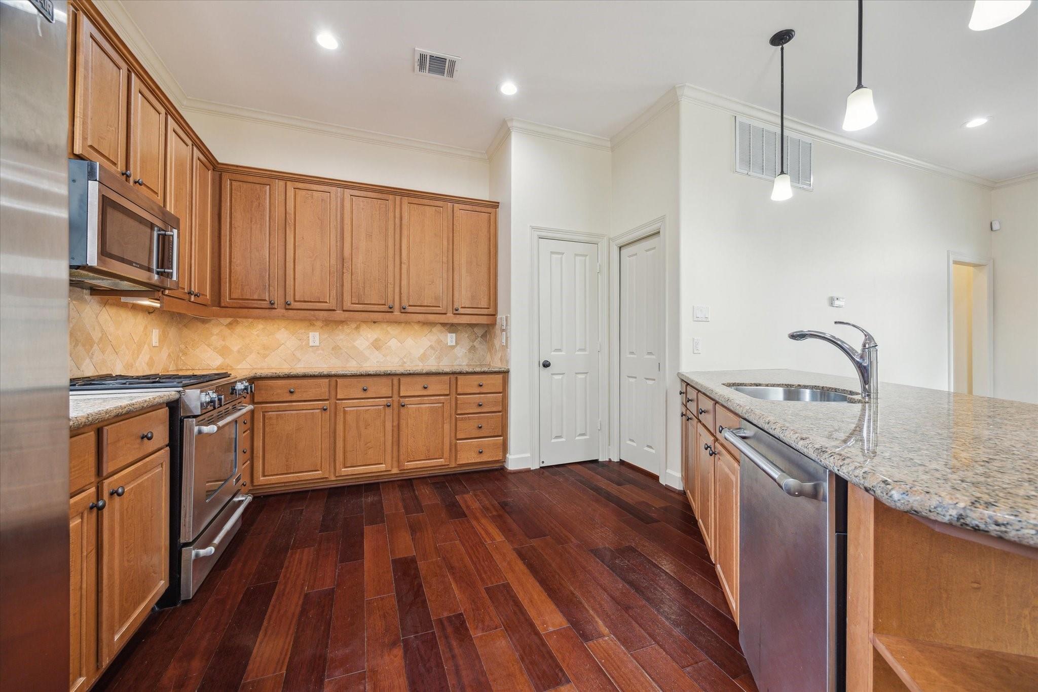 Kitchen with wood cabinetry and stainless steel appliances