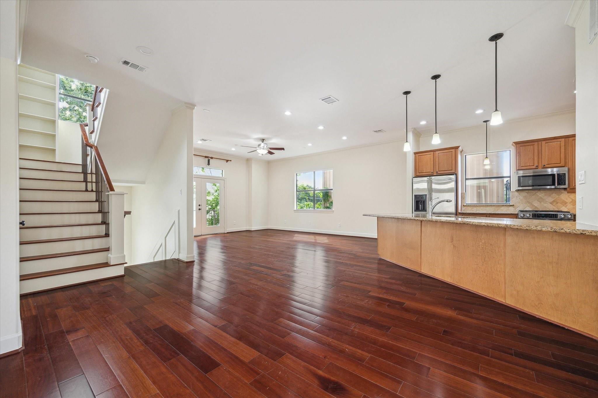 Unfurnished second-floor open living area with wood flooring