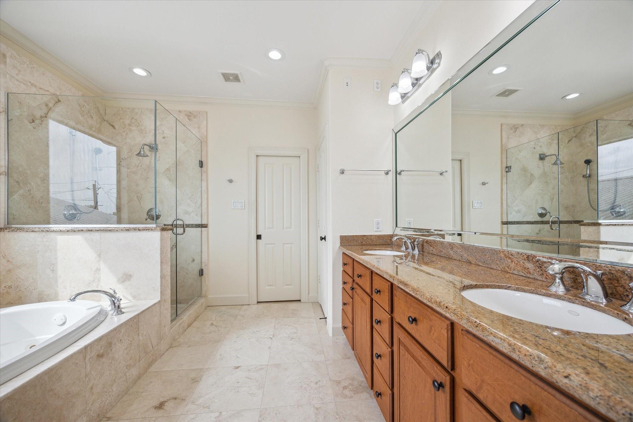 Primary bathroom with dual sinks, jetted tub and separate shower