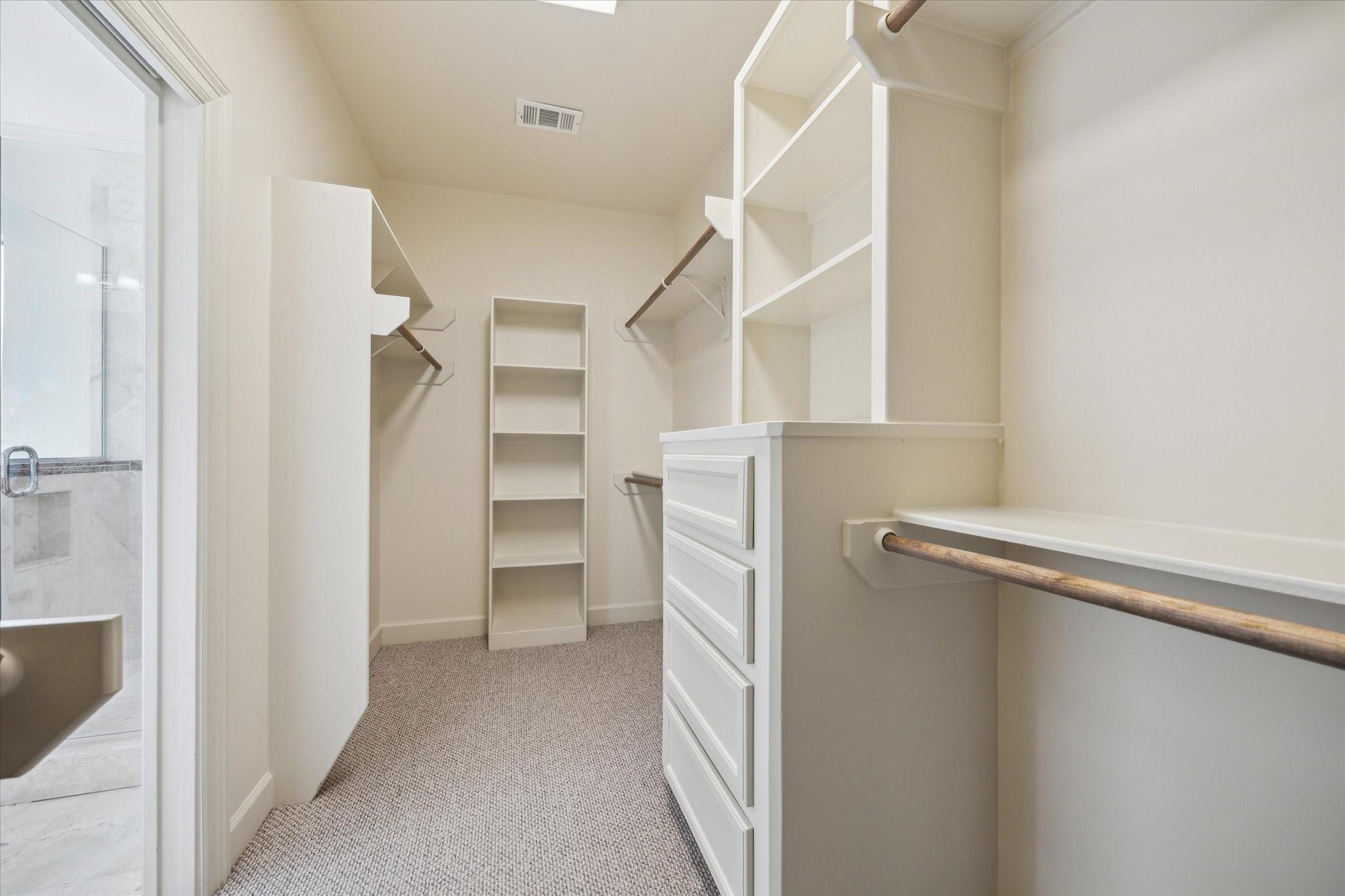 Primary walk-in closet with built-in storage