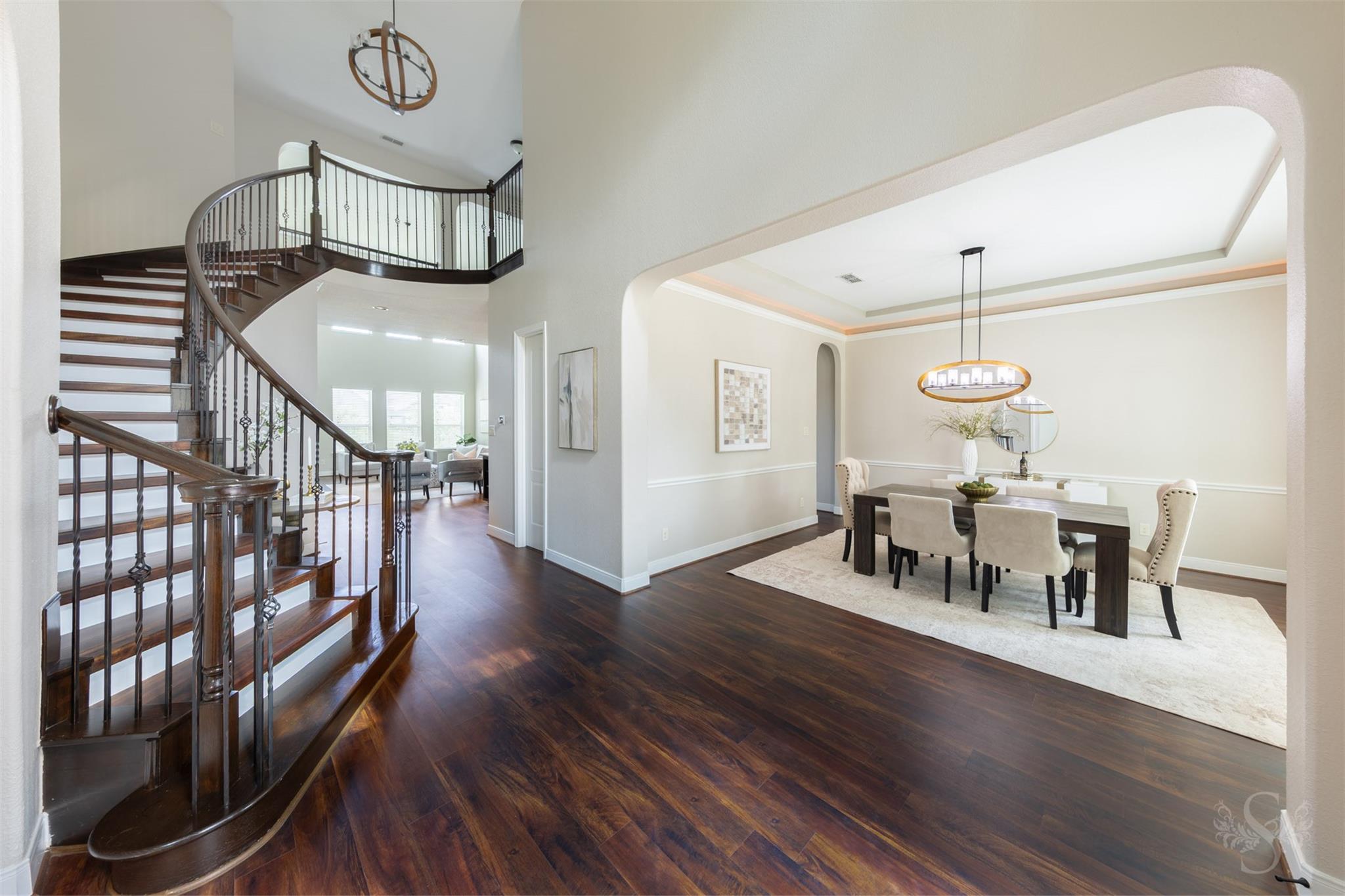 Two-story foyer and curved staircase at 5026 Quiet Falls Lane