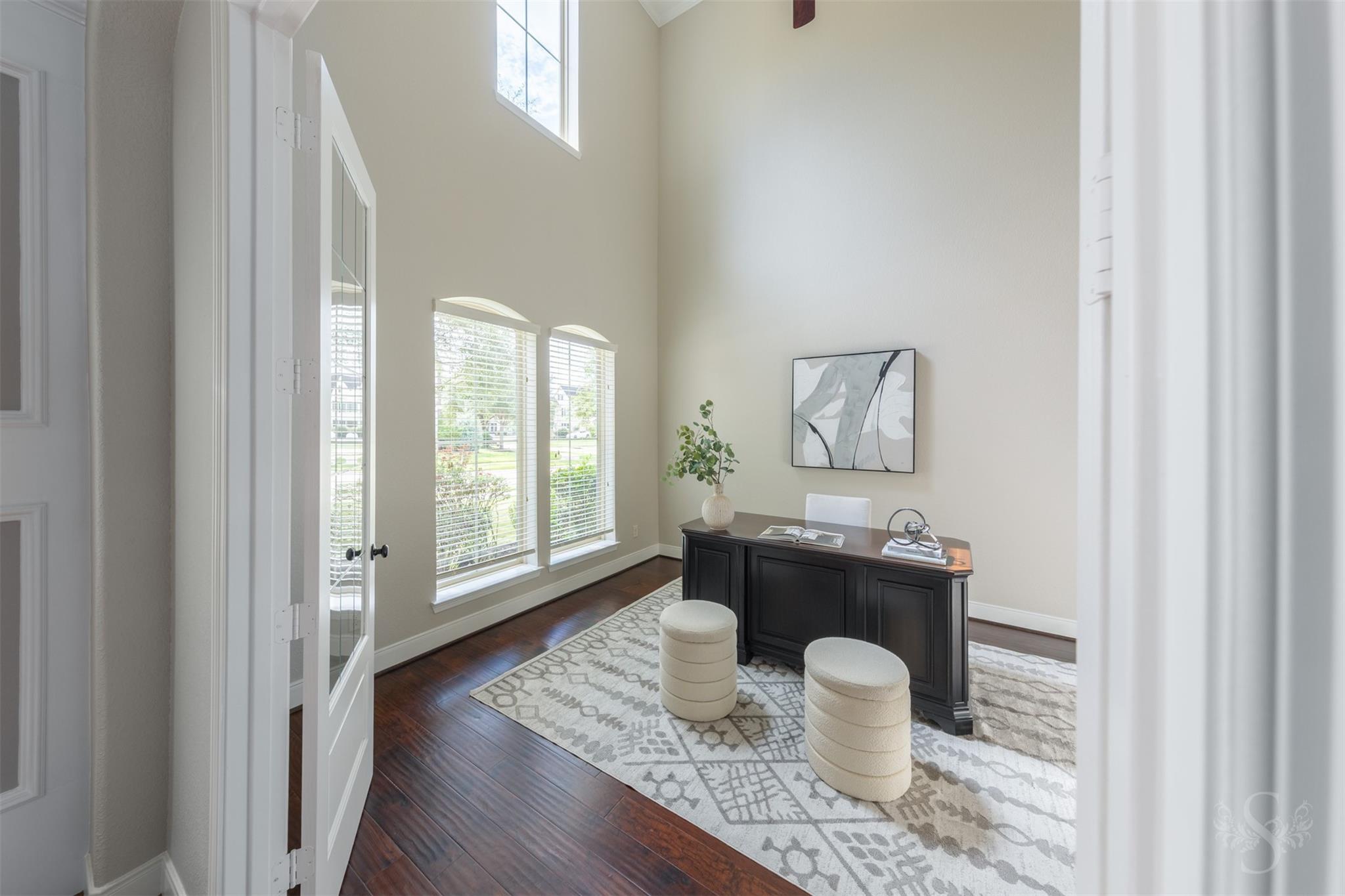 Bright home office with tall windows at 5026 Quiet Falls Lane