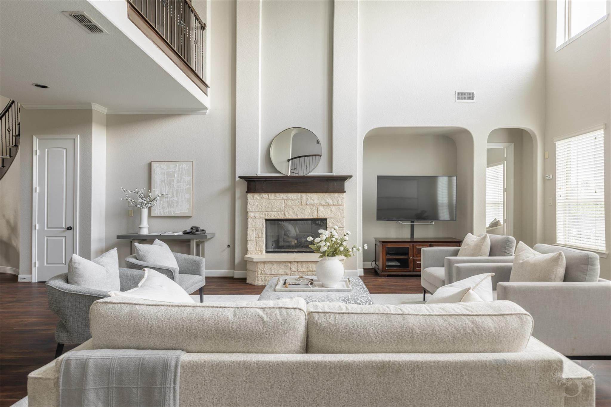 Stone fireplace in the two-story family room at 5026 Quiet Falls Lane