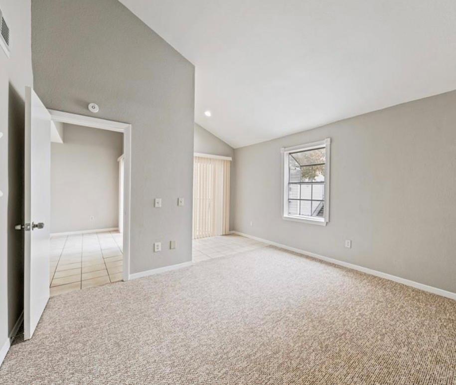 Unfurnished primary bedroom with carpet