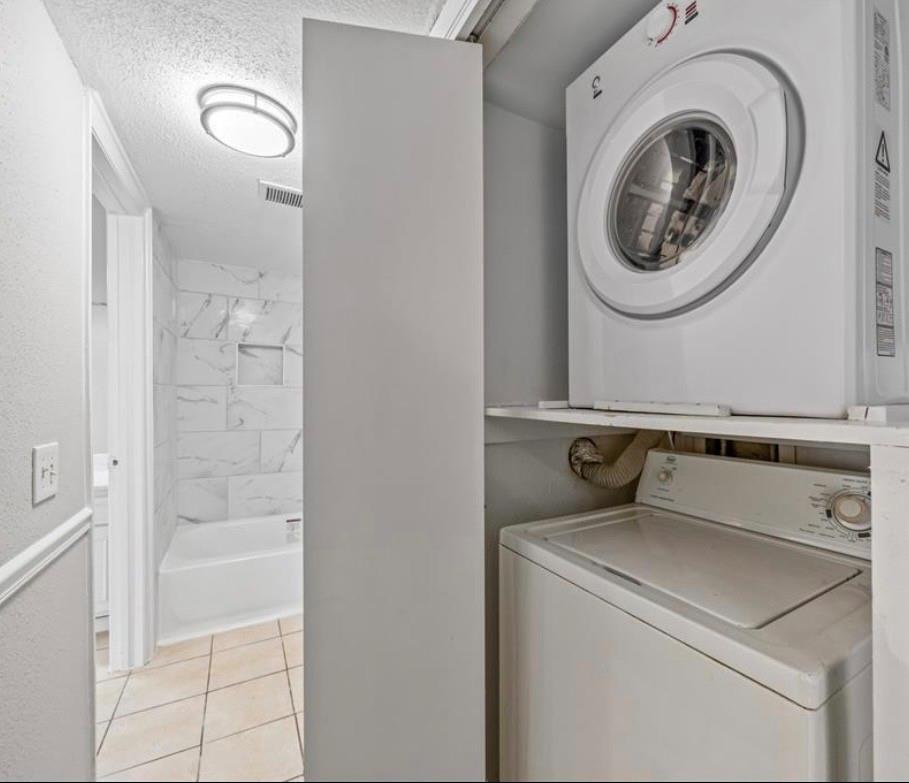 In-unit stacked washer and dryer
