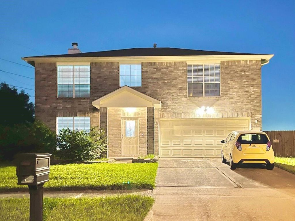 Front exterior at dusk of 16959 Great Glen Dr in Houston