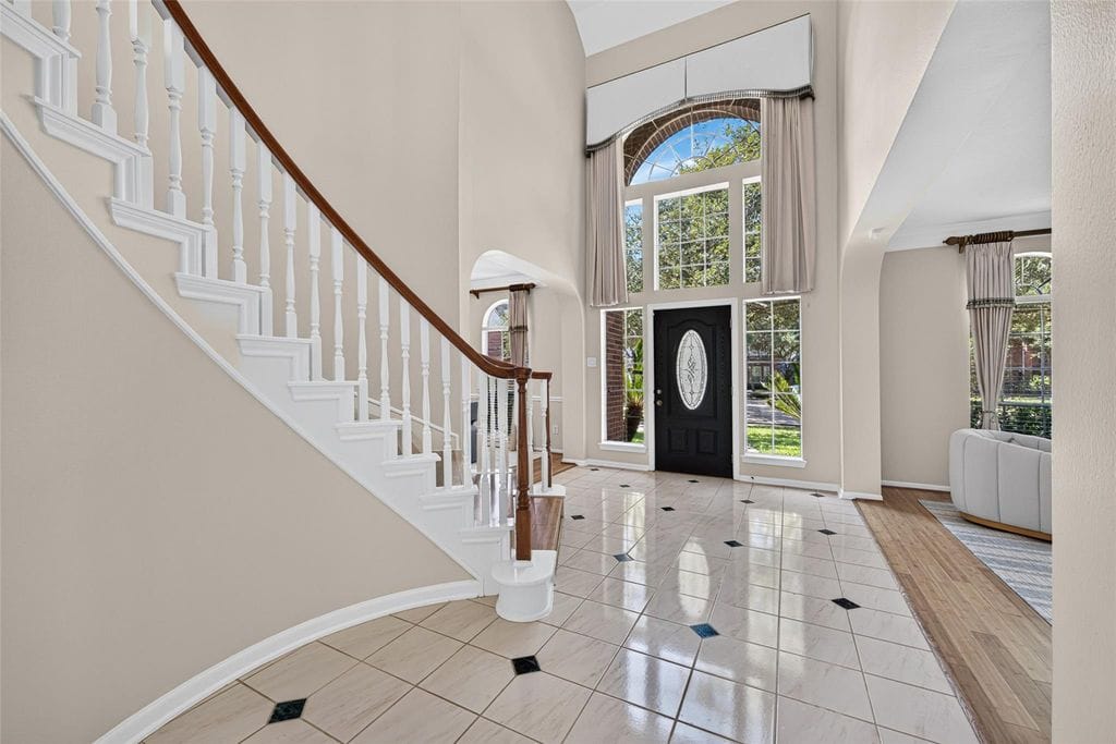 Bright entry hall and custom staircase at 2819 Gray Moss Ct