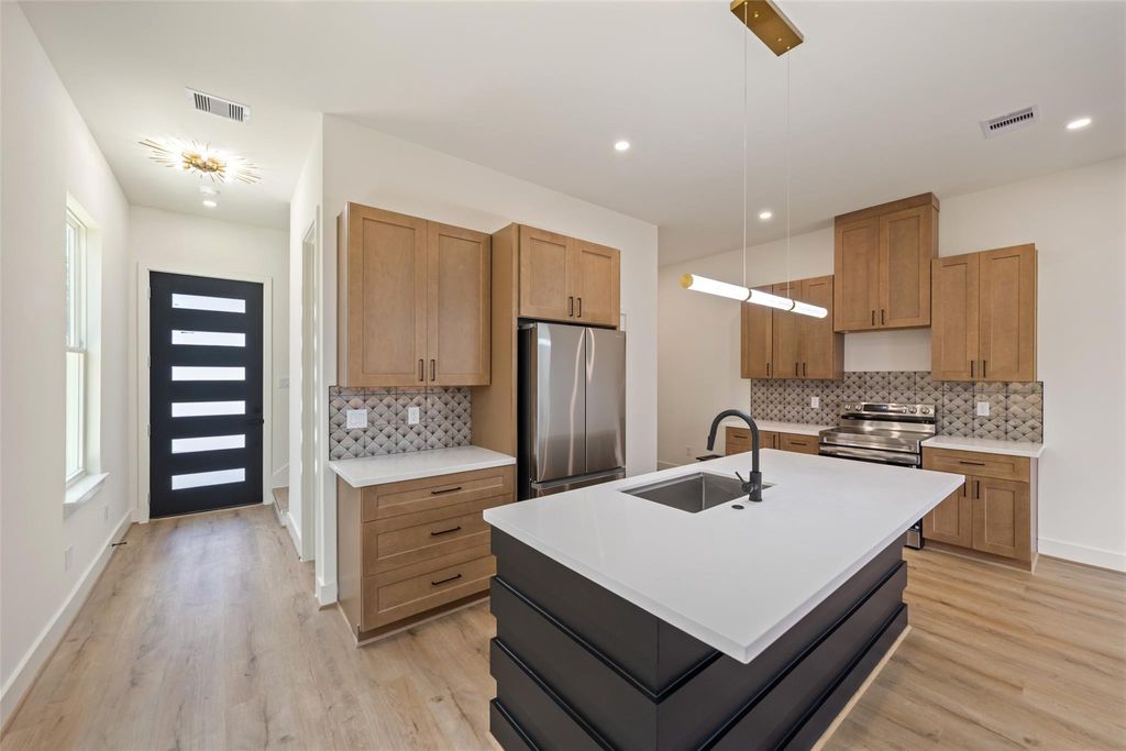 Unit B quartz island, wood cabinetry and stainless appliances | B单元石英岛台、木色橱柜及不锈钢电器