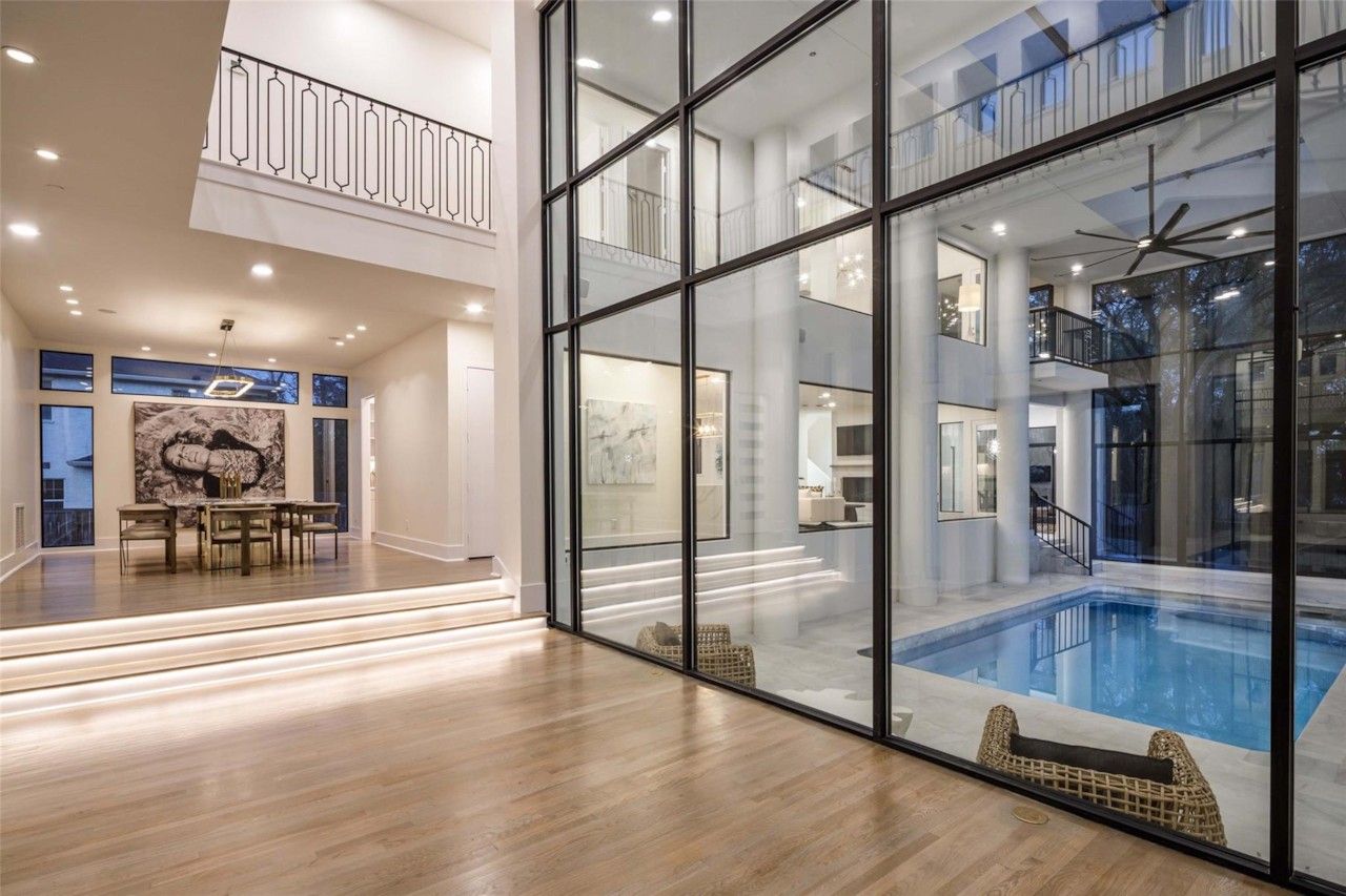 Open living space beside the glass-enclosed indoor pool