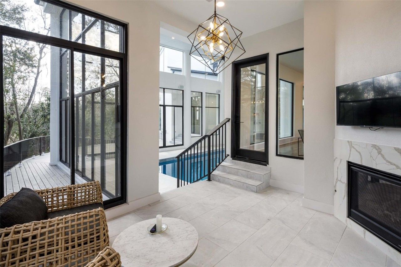 Indoor pool lounge with fireplace and television