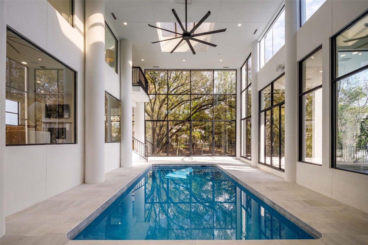 Indoor pool surrounded by white marble decking