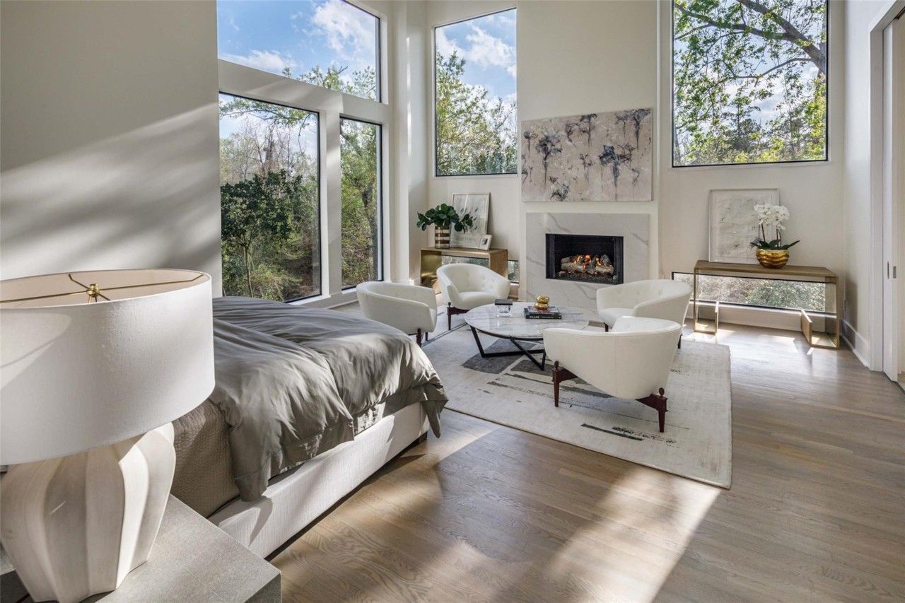 Bedroom sitting area with fireplace and large windows