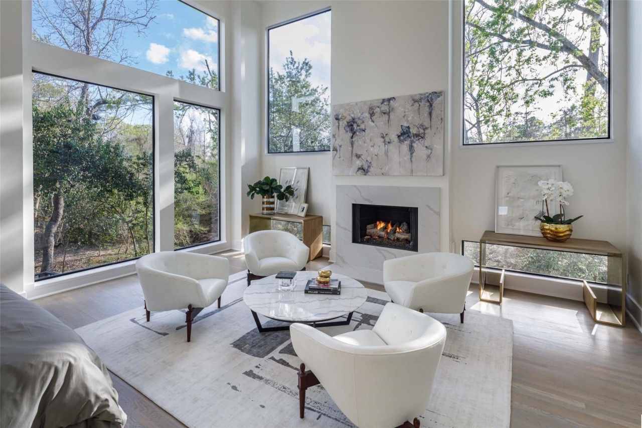 Bedroom lounge with tall windows and wooded views