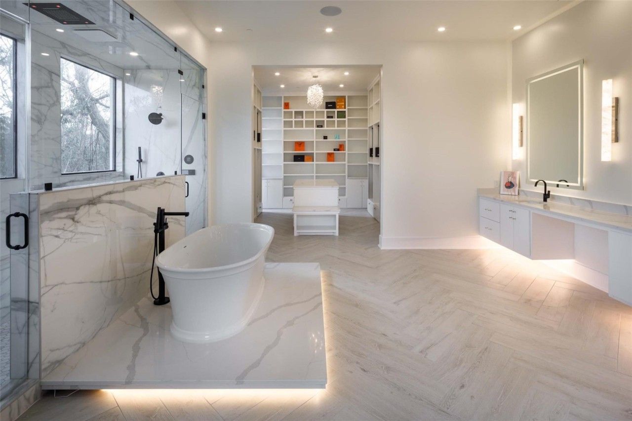 Spa-style primary bathroom with soaking tub and double vanity