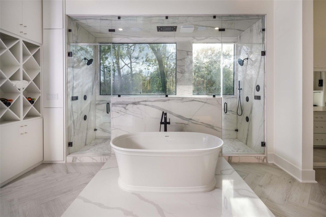 Freestanding soaking tub and oversized marble shower