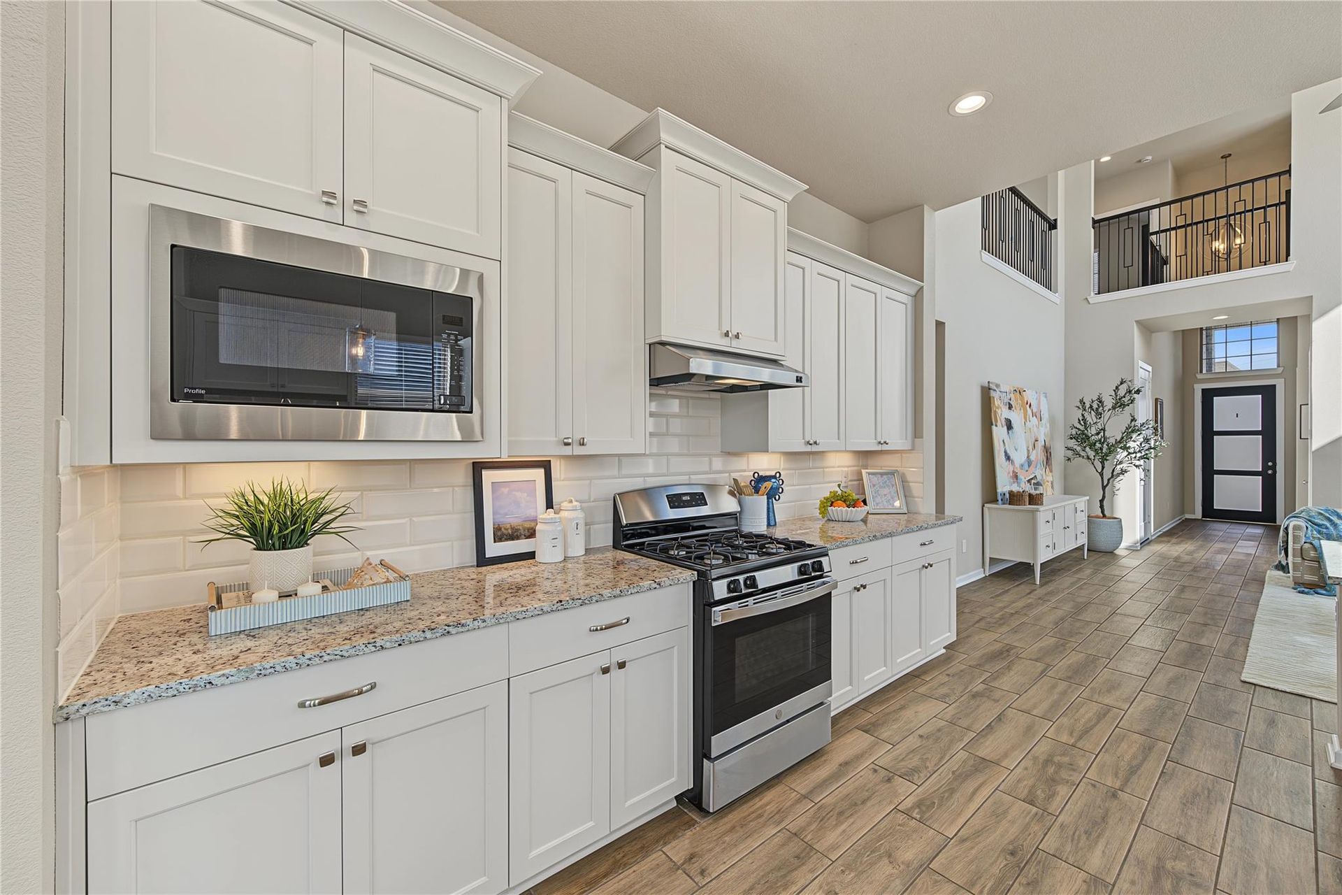 Gas range, microwave and white kitchen cabinetry | 燃气灶、微波炉与白色橱柜