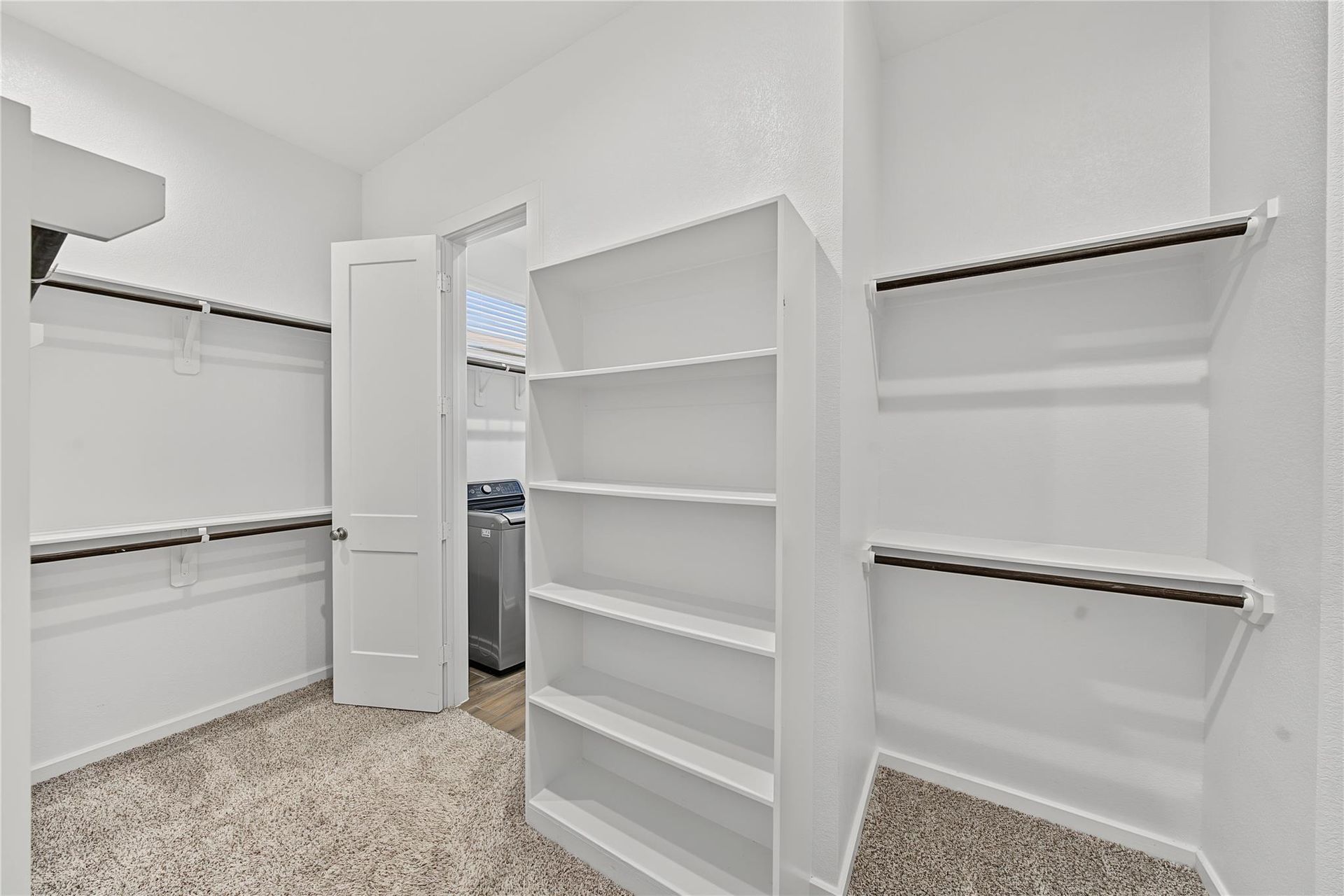 Walk-in primary closet with built-in shelving | 带置物架的主卧步入式衣橱