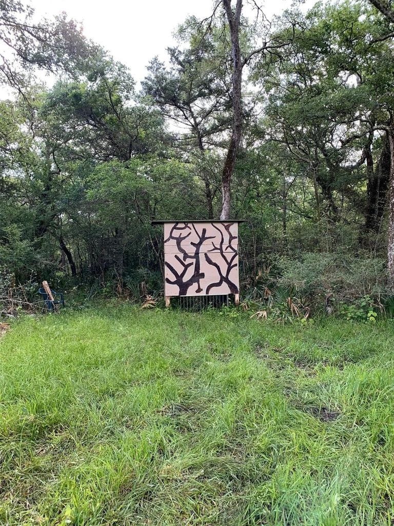Ground hunting blind positioned along the wooded edge of the acreage